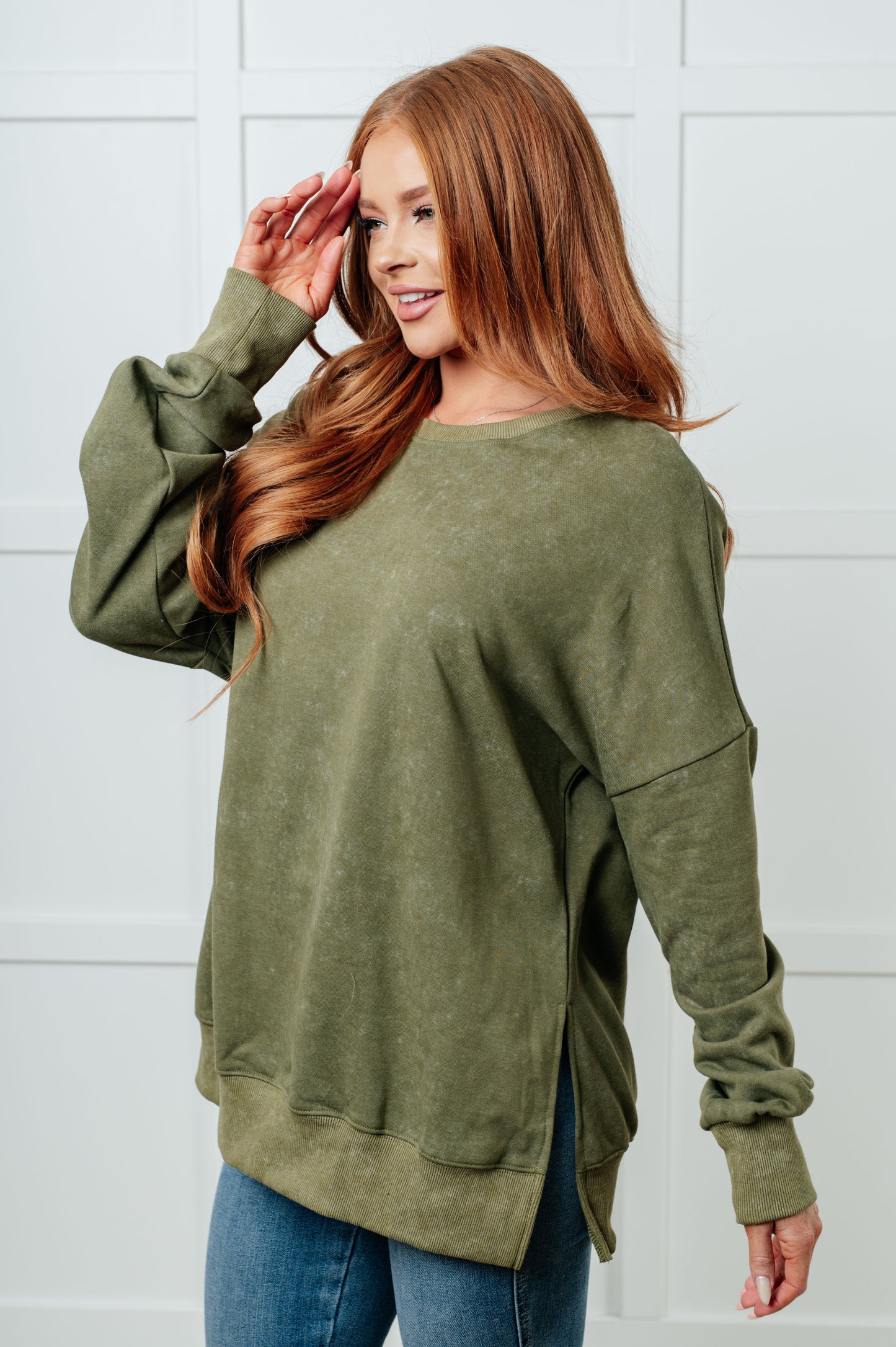 A women's French terry sweatshirt in mineral wash green with a crew neckline, long sleeves, side slits, and ribbed cuffs and hem. 