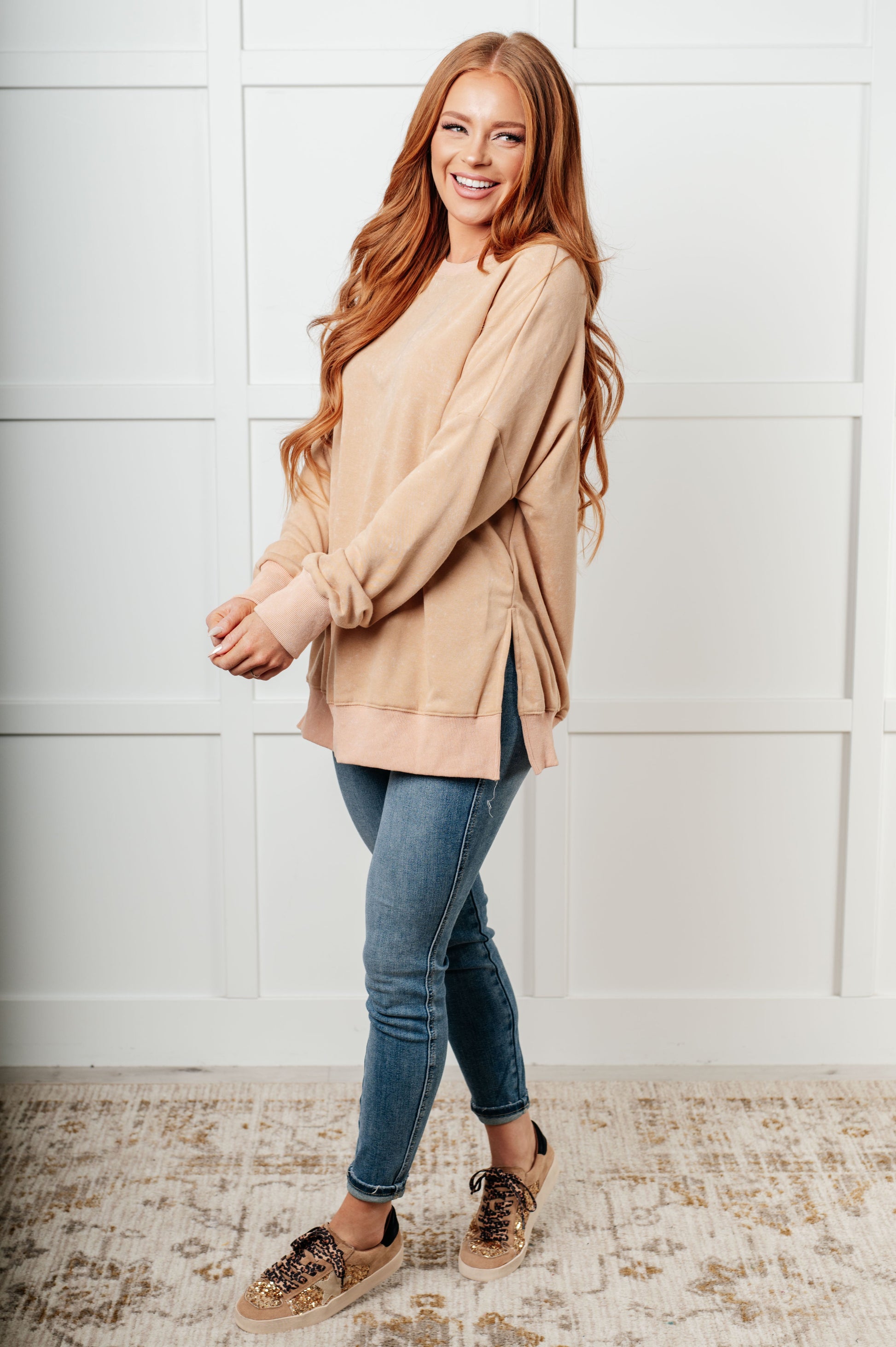 A women's French terry sweatshirt in mineral wash khaki with a crew neckline, long sleeves, side slits, and ribbed cuffs and hem. 