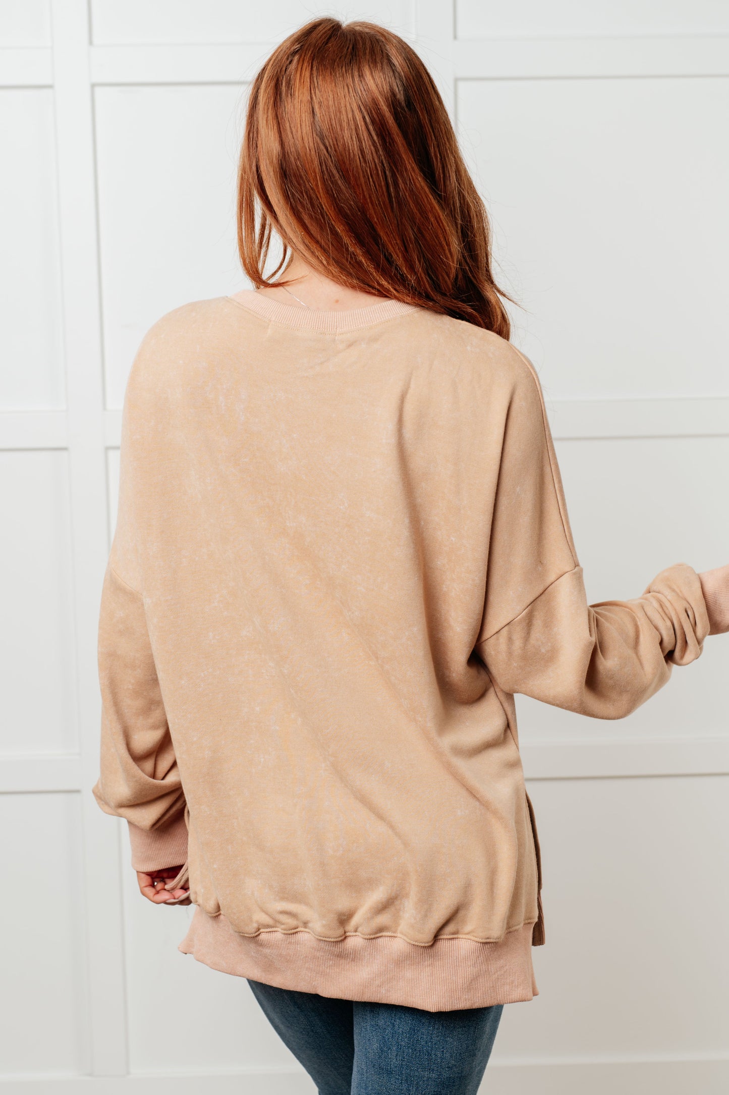 A women's French terry sweatshirt in mineral wash khaki with a crew neckline, long sleeves, side slits, and ribbed cuffs and hem. 