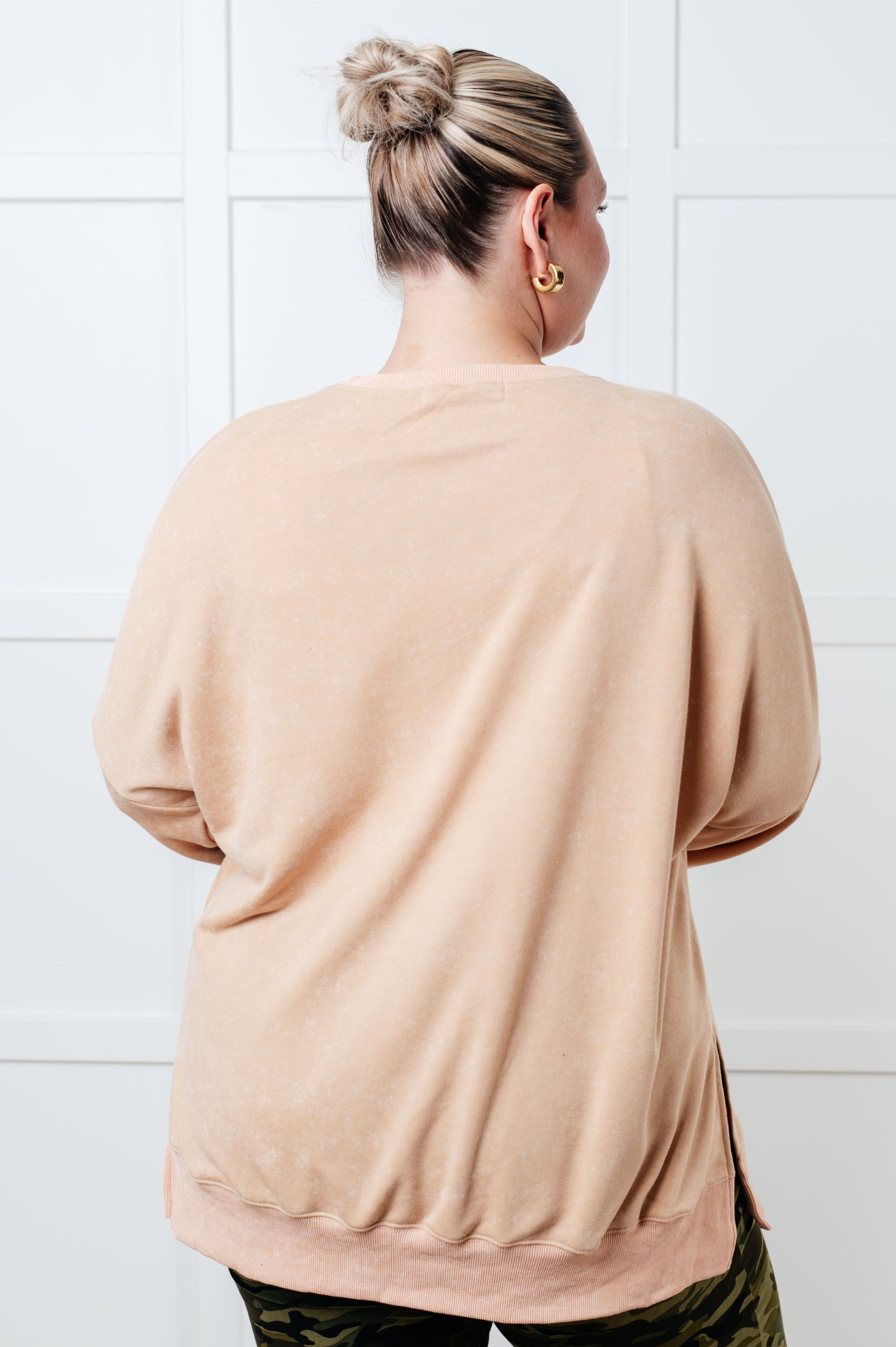 A women's French terry sweatshirt in mineral wash khaki with a crew neckline, long sleeves, side slits, and ribbed cuffs and hem. 