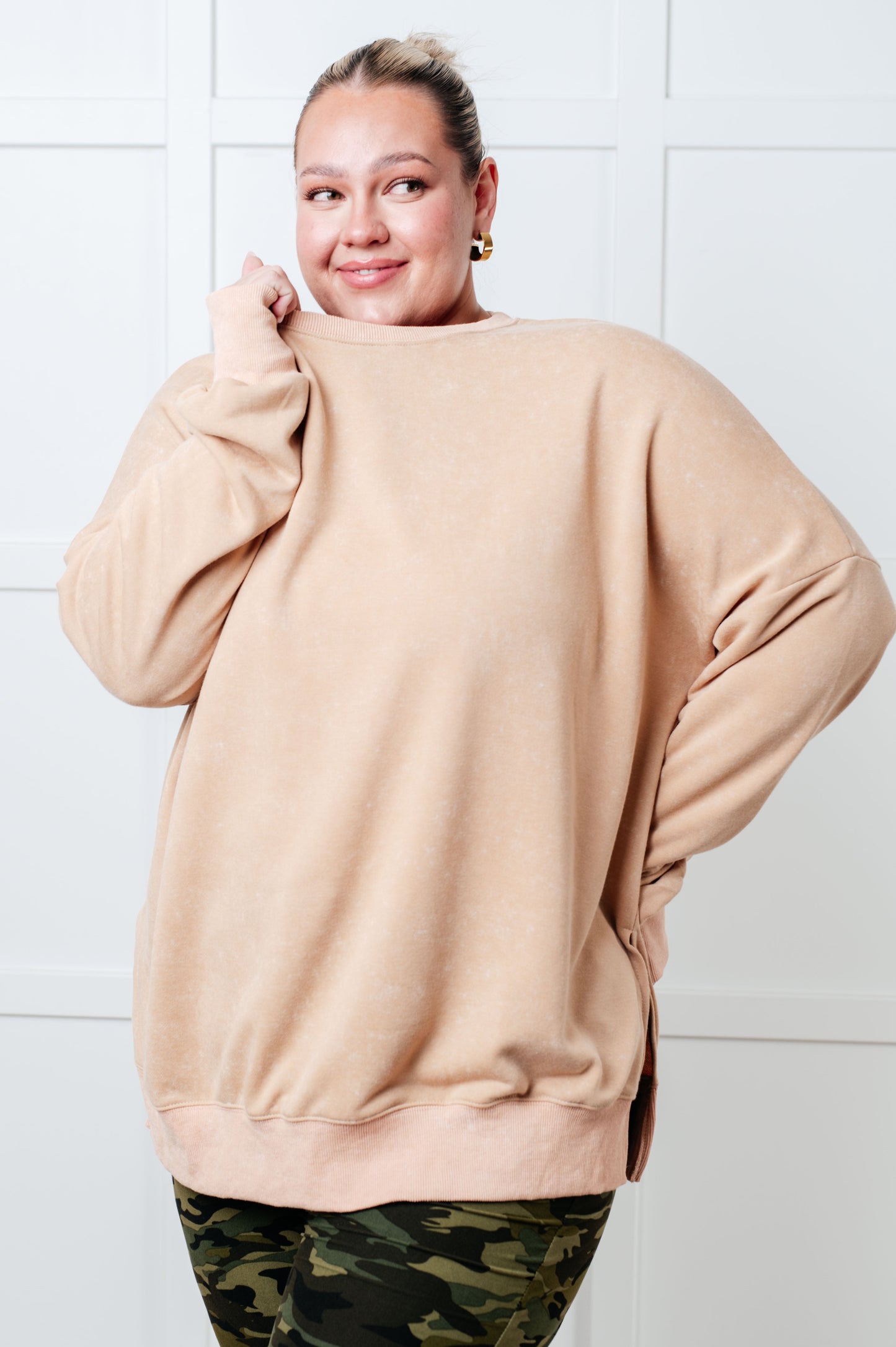 A women's French terry sweatshirt in mineral wash khaki with a crew neckline, long sleeves, side slits, and ribbed cuffs and hem. 