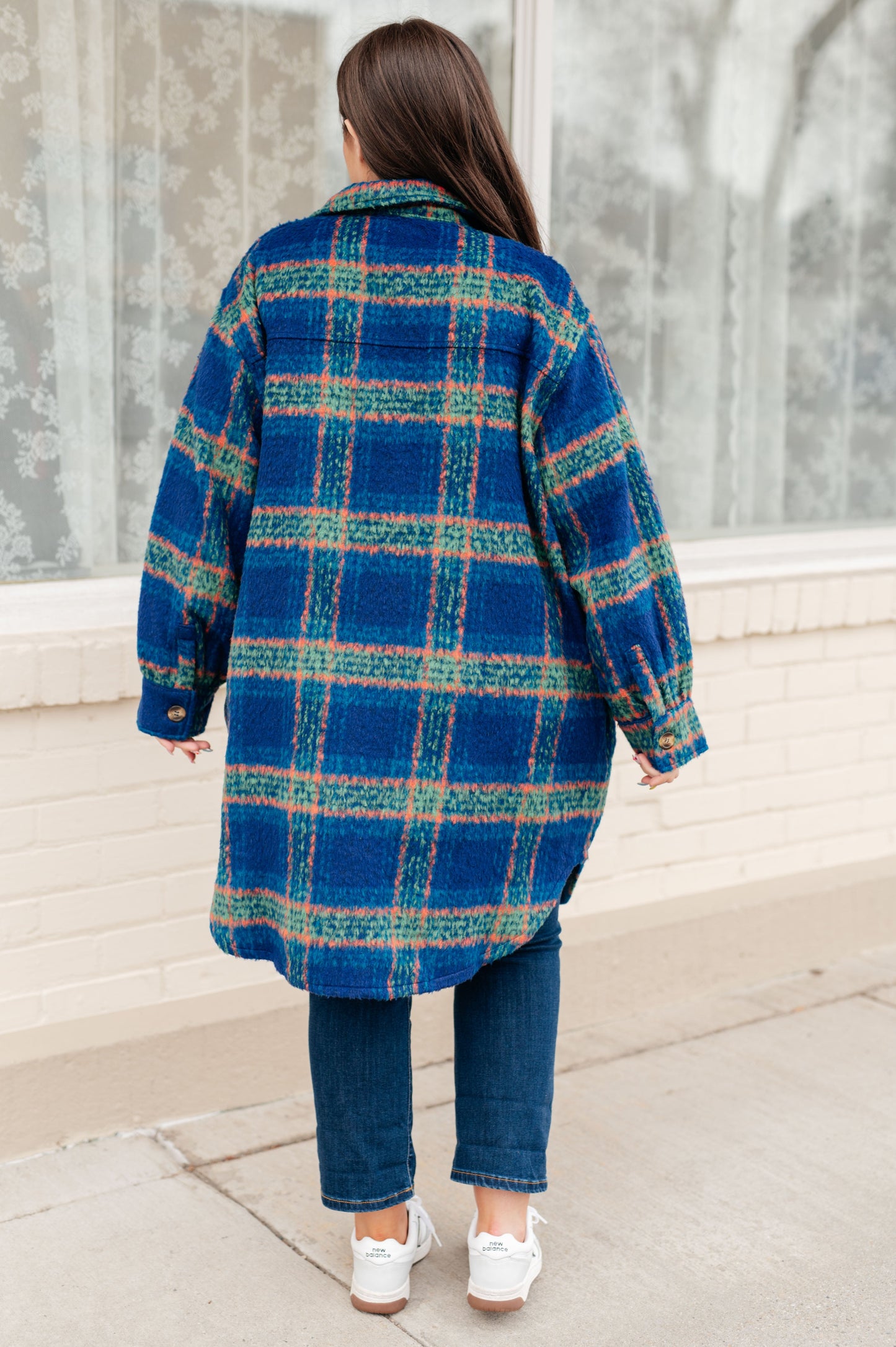 Back view of Nona Plaid Coat in blue plaid with scooped hem detail.