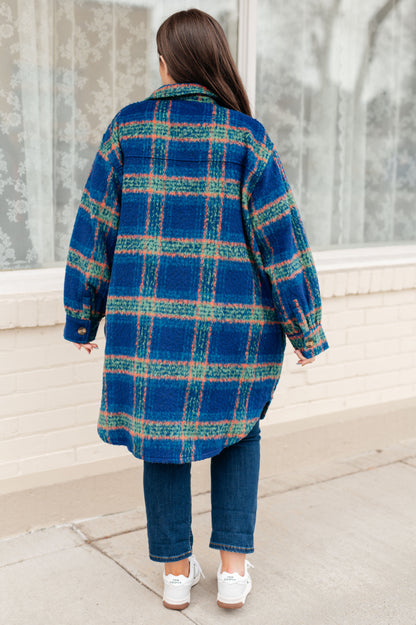 Back view of Nona Plaid Coat in blue plaid with scooped hem detail.
