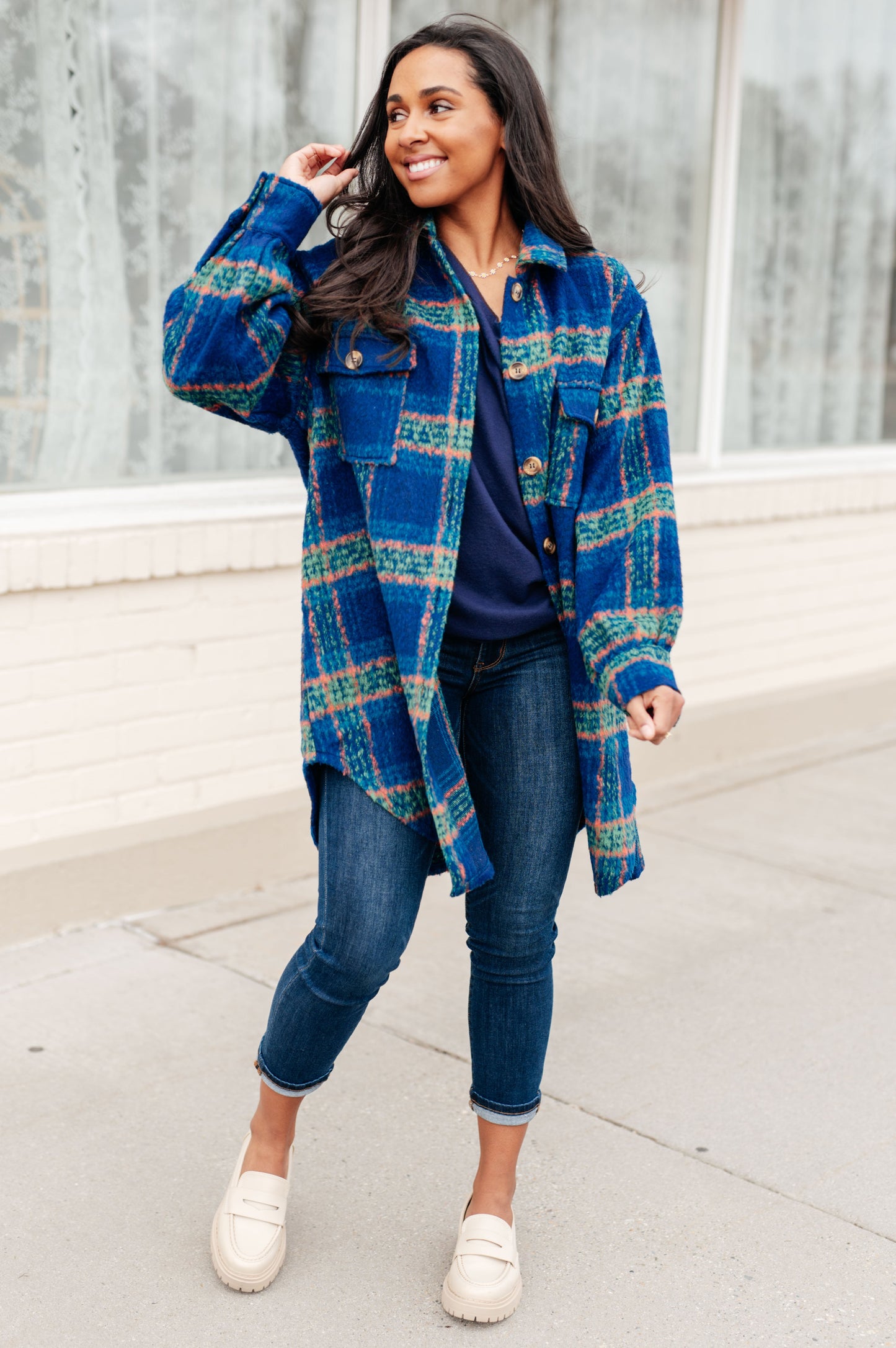 Model styling Nona Plaid Coat layered over sweater and jeans for cold weather.