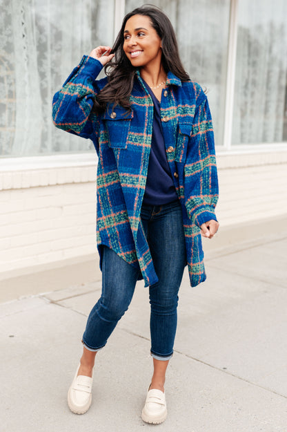 Model styling Nona Plaid Coat layered over sweater and jeans for cold weather.