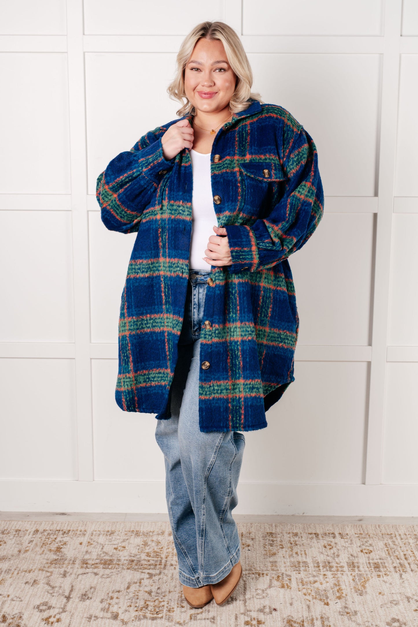 Plus size model wearing Nona Plaid Coat in blue flannel with collared neckline.
