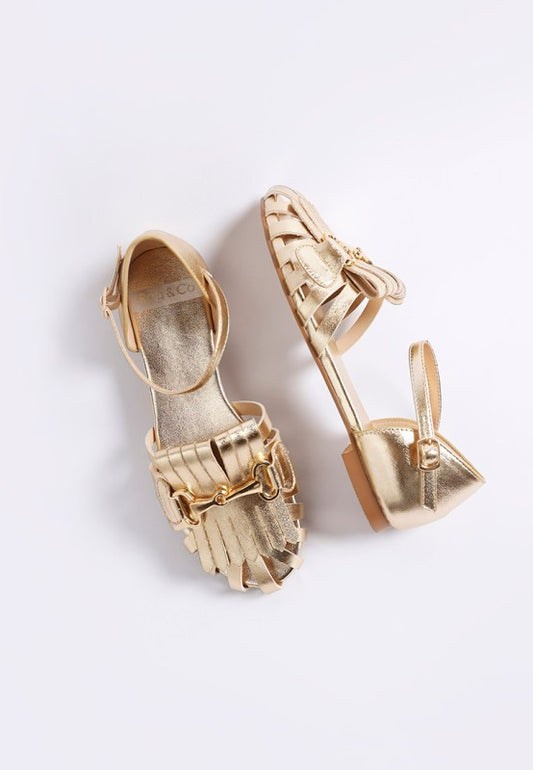 Front view of Noori Metallic Fringe Flat Sandals showing cut-out vamp design.