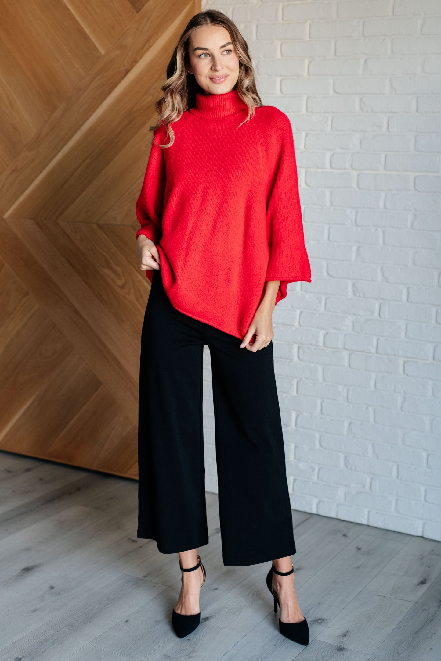 Women's turtleneck sweater in red-orange sweater knit, featuring wide raglan 3/4 length sleeves and a relaxed fit.