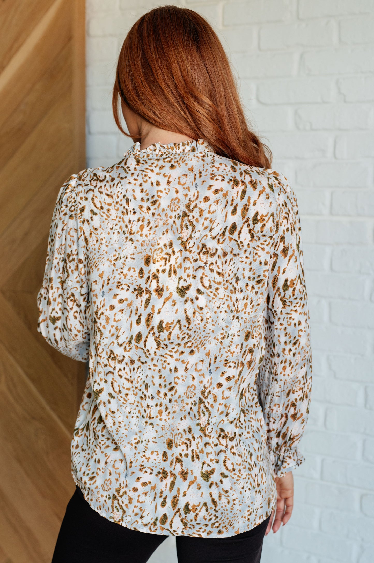 Back view of Bellamy Keyhole Tie Blouse showing safari brown animal print and soft drape.