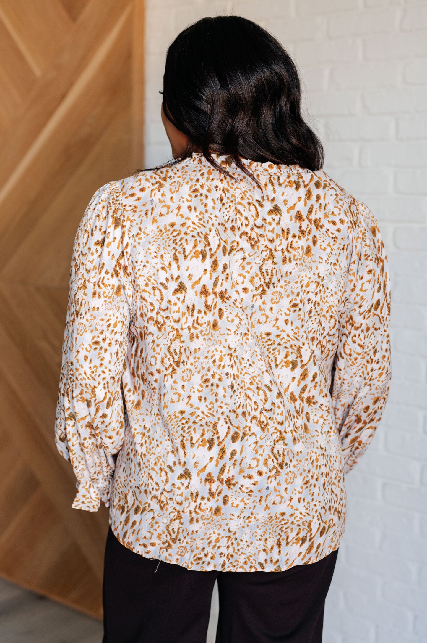 Plus size back view of Bellamy Keyhole Tie Blouse with relaxed fit and ruffled cuff details.