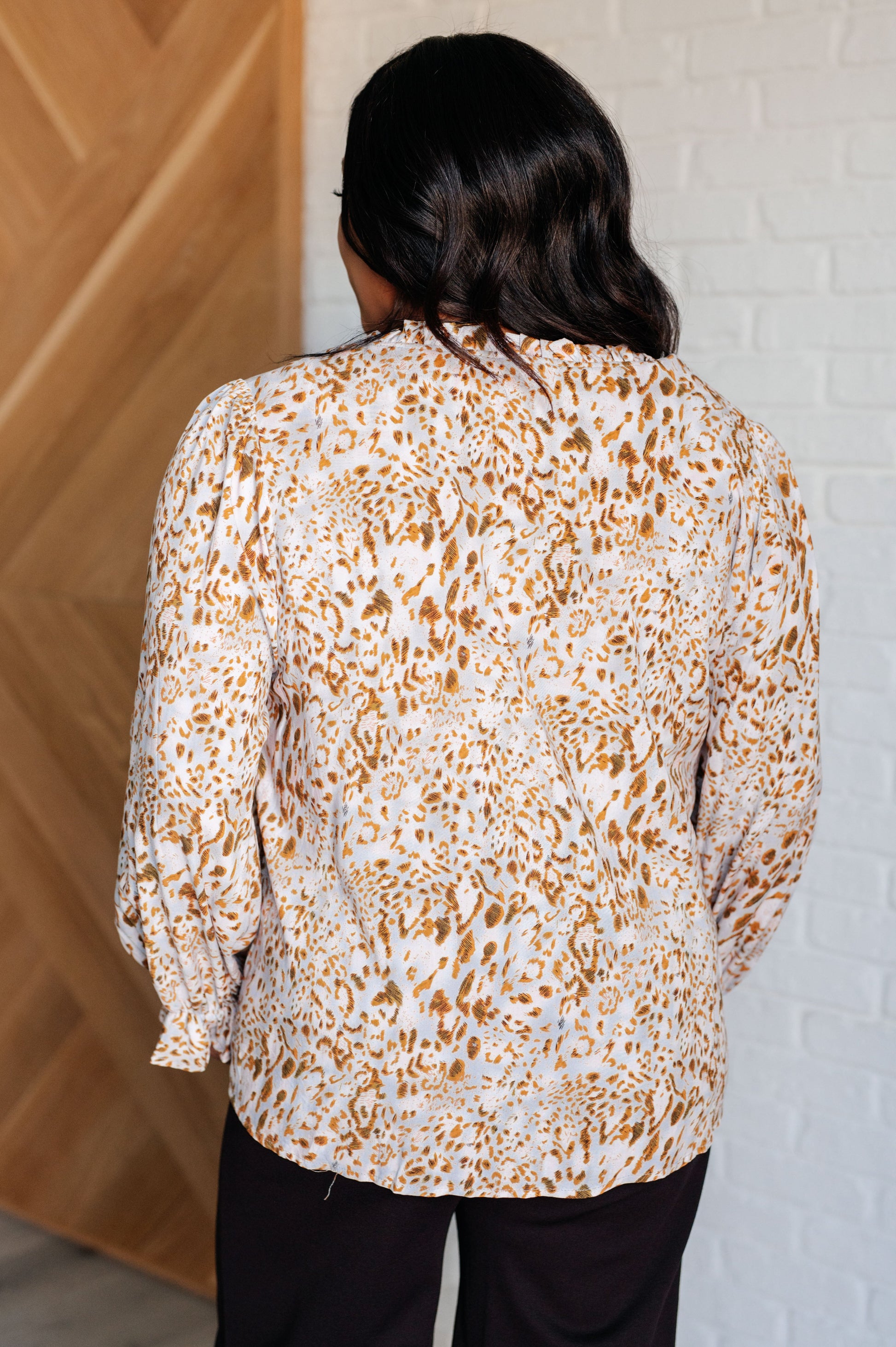 Plus size back view of Bellamy Keyhole Tie Blouse with relaxed fit and ruffled cuff details.