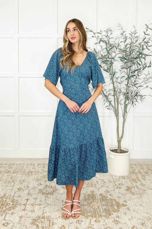 Front view of Olive Blue Floral Dress with scooped neckline, raglan sleeves, and functional zip front.