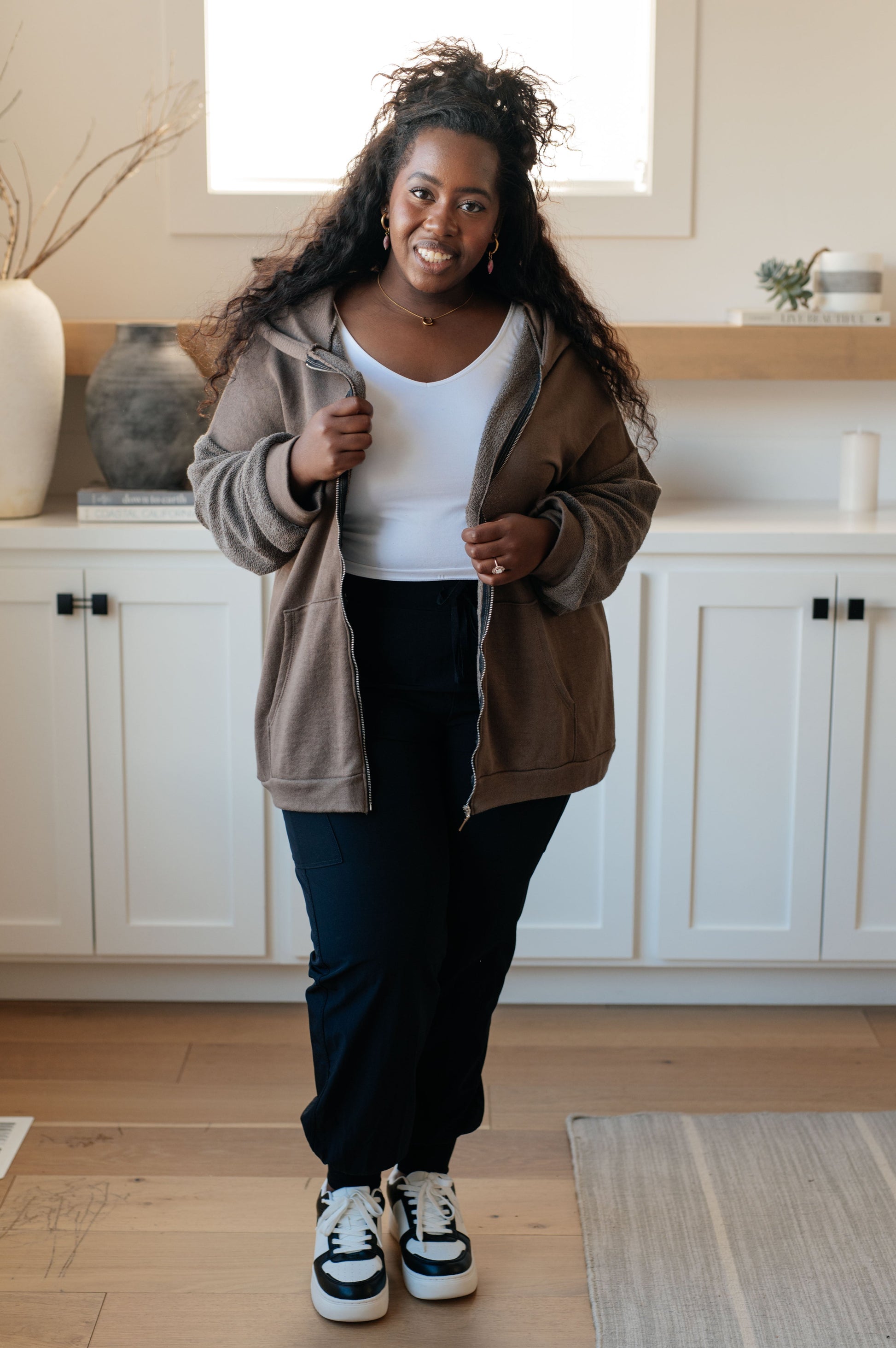 Taupe zip-up hoodie with French terry fabric, reverse-french terry sleeves, a hooded neckline, and long dropped shoulder sleeves.