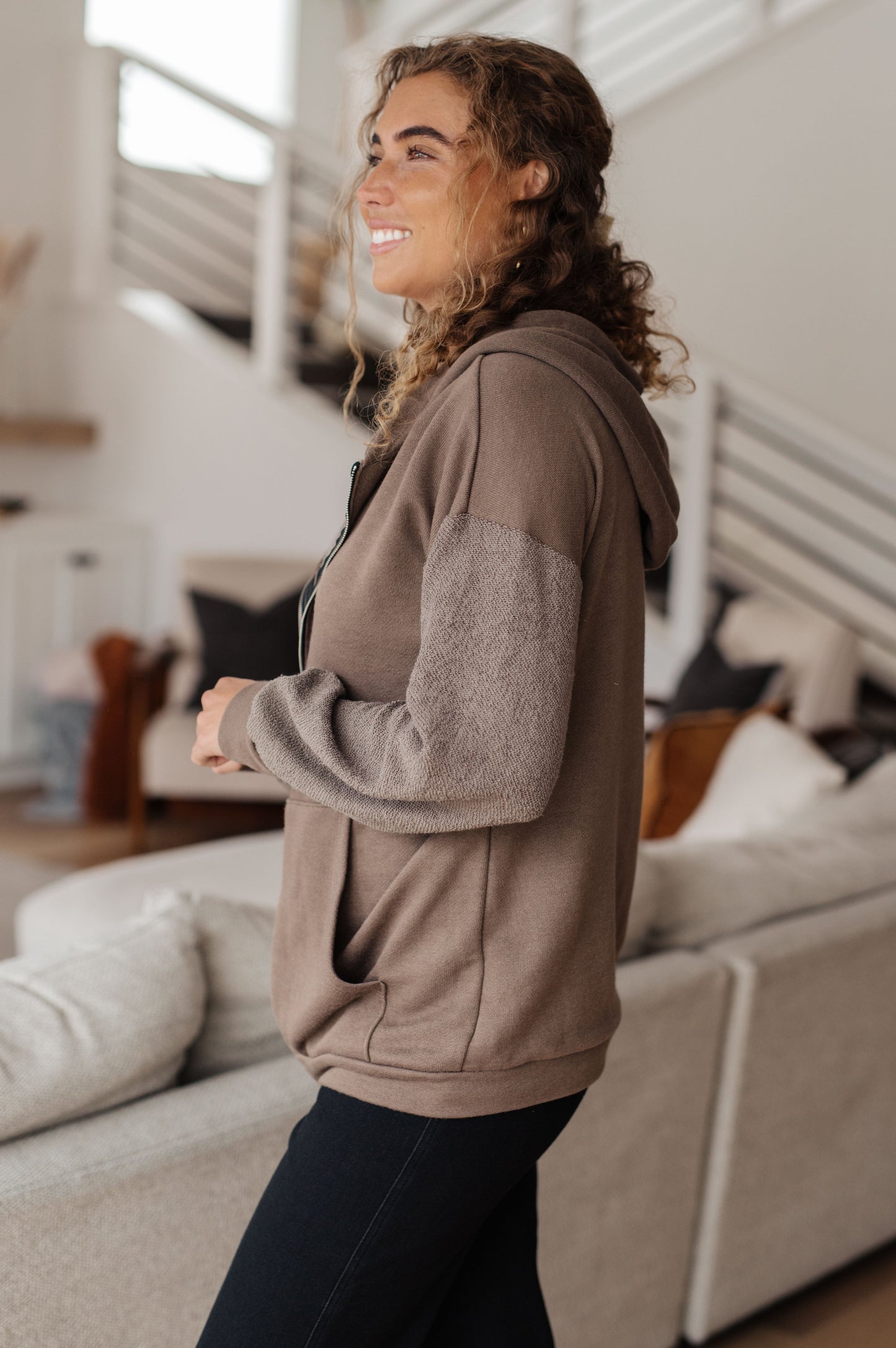 Taupe zip-up hoodie with French terry fabric, reverse-french terry sleeves, a hooded neckline, and long dropped shoulder sleeves.