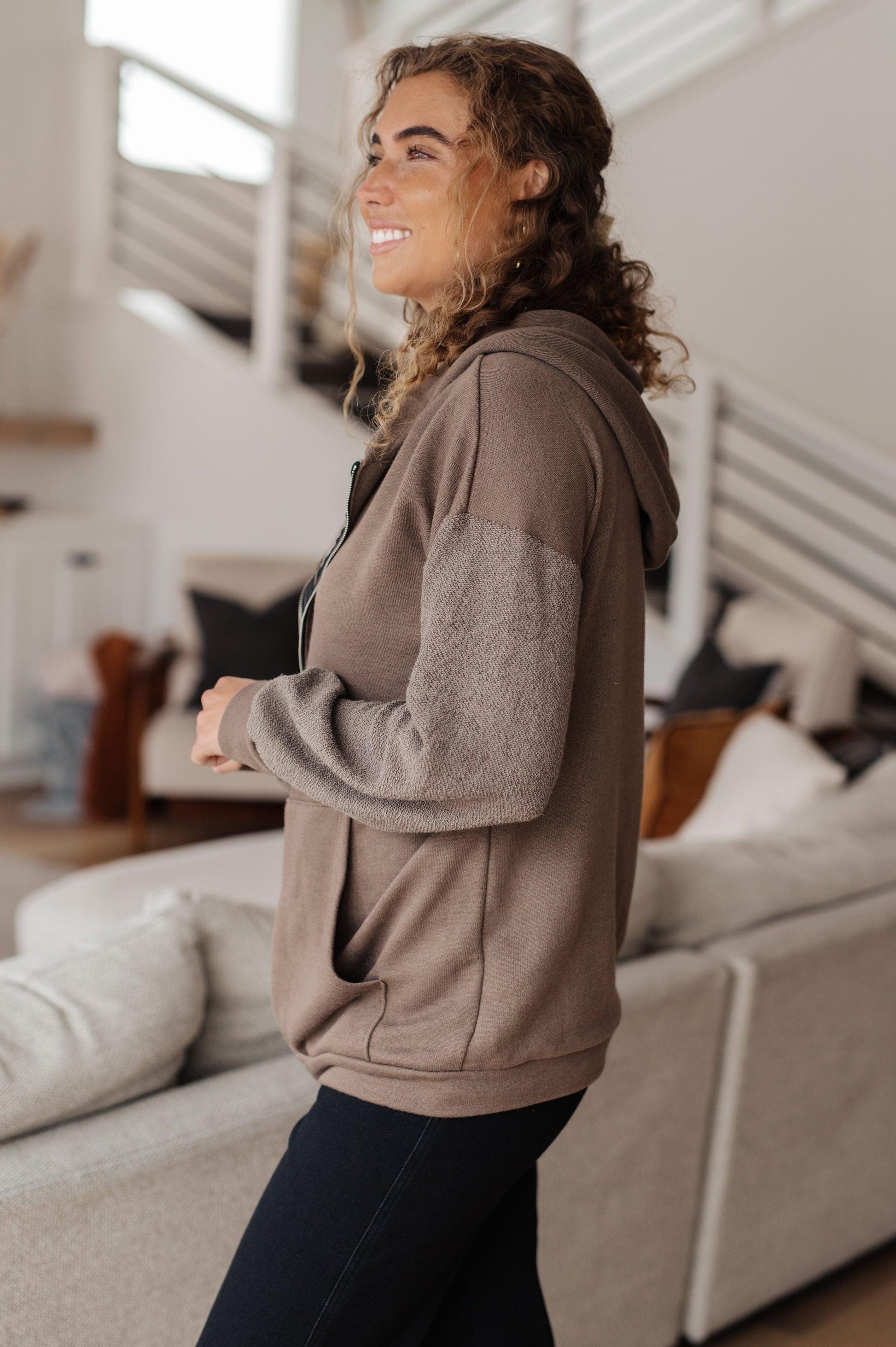 Taupe zip-up hoodie with French terry fabric, reverse-french terry sleeves, a hooded neckline, and long dropped shoulder sleeves.