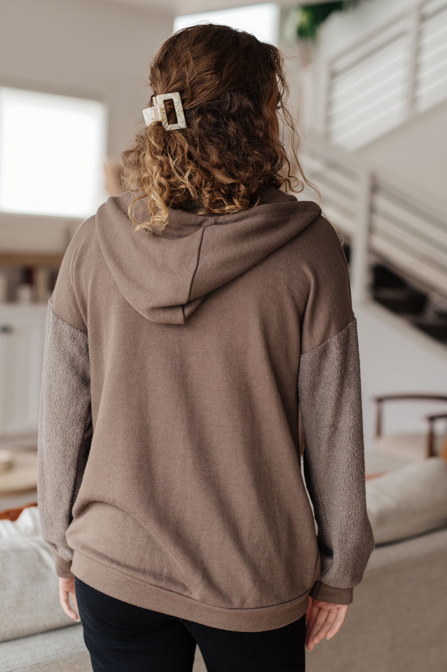 Taupe zip-up hoodie with French terry fabric, reverse-french terry sleeves, a hooded neckline, and long dropped shoulder sleeves.