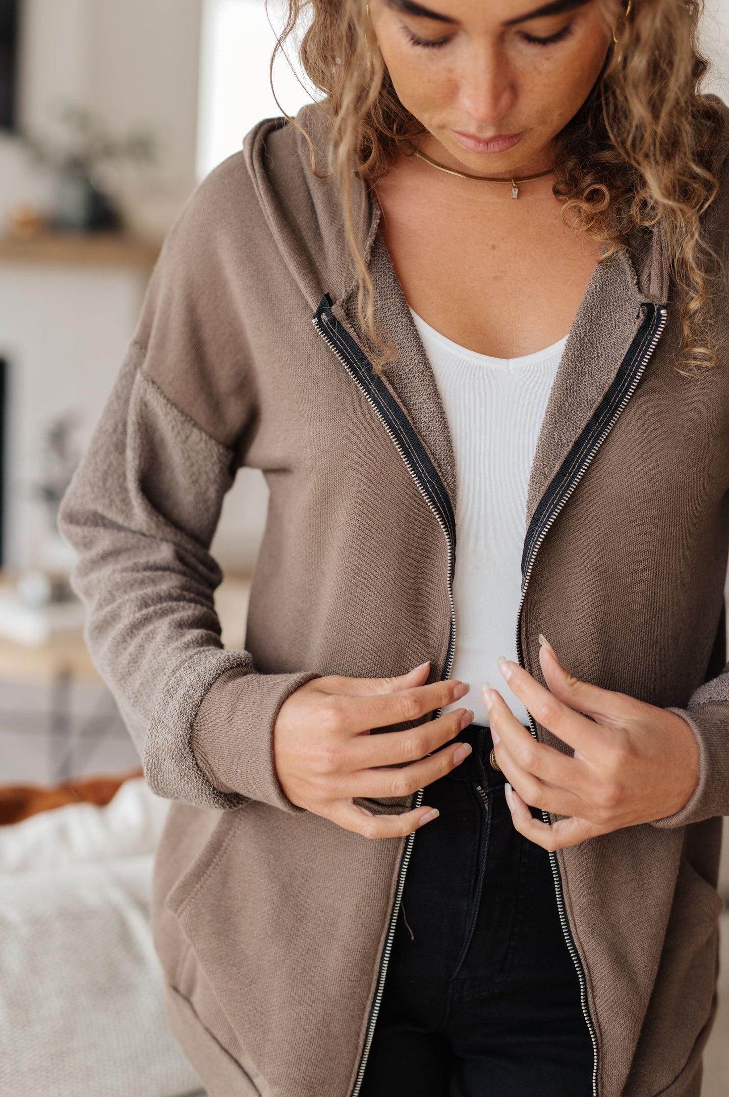 Taupe zip-up hoodie with French terry fabric, reverse-french terry sleeves, a hooded neckline, and long dropped shoulder sleeves.