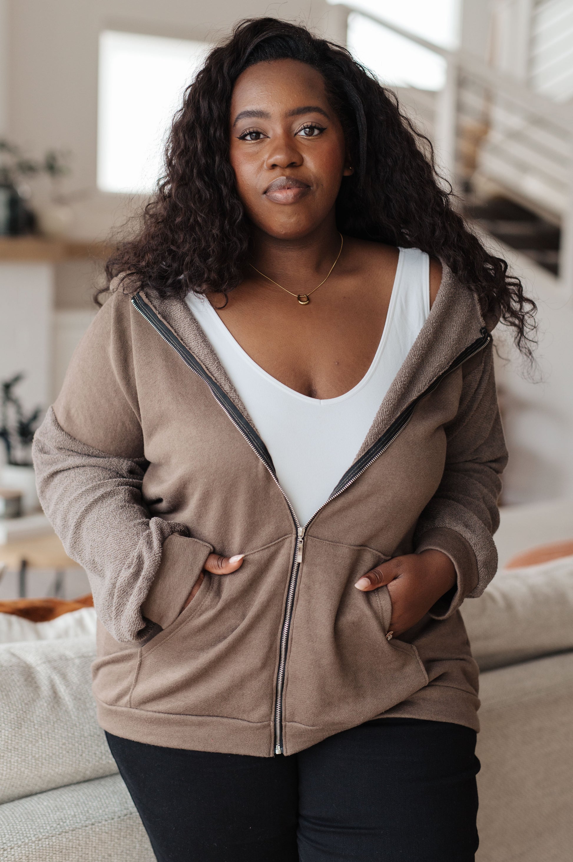 Taupe zip-up hoodie with French terry fabric, reverse-french terry sleeves, a hooded neckline, and long dropped shoulder sleeves.