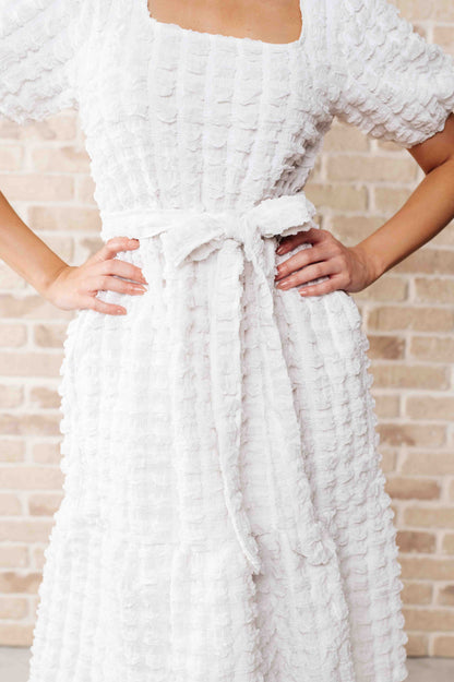 Close-up of the Ivy Bubble Midi Dress highlighting bubble knit texture, square neckline, and self-tie waist belt.