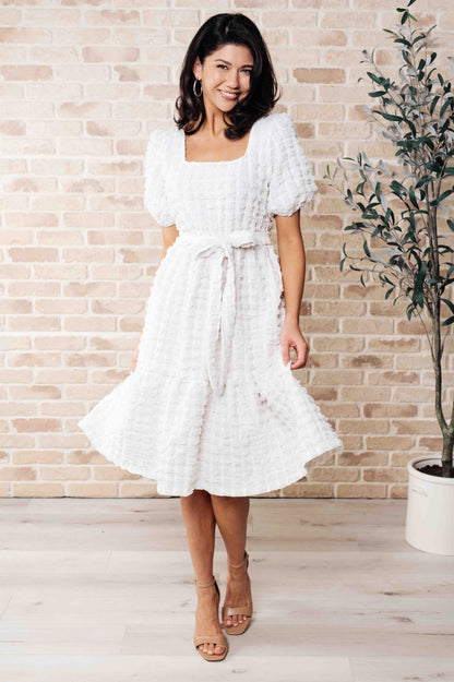Front view of the Ivy Bubble Midi Dress in white, featuring square neckline, balloon sleeves, and tiered skirt.