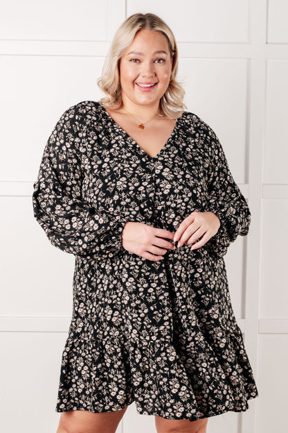 Plus size model twirling in Onna V-Neck Floral Dress showing flowy mini hemline.