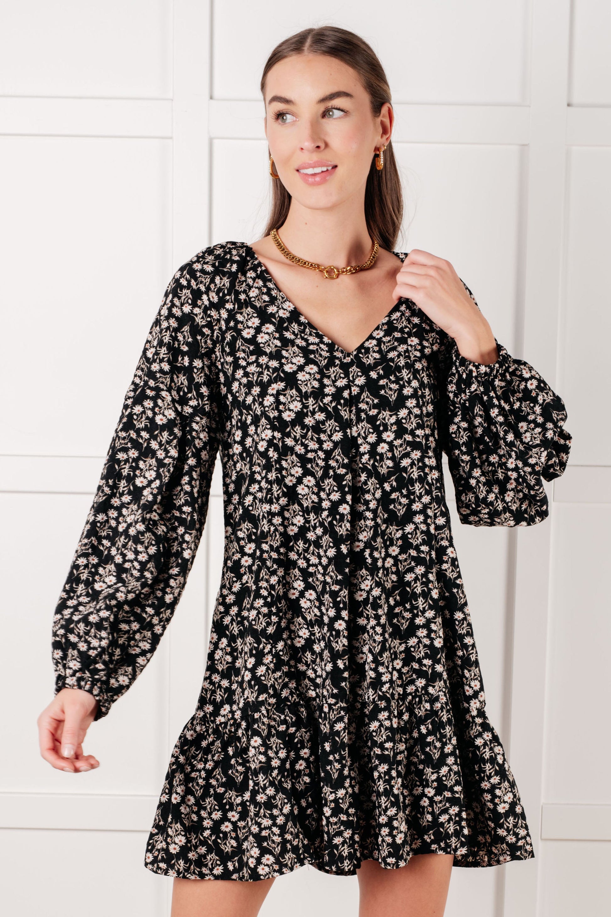 Model twirling in Onna V-Neck Floral Dress showing flowy mini-length hem.
