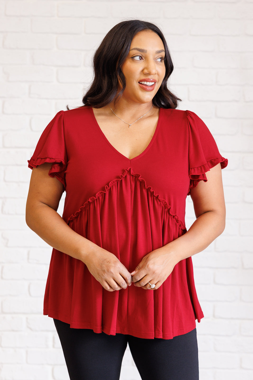 Ophelia V-Neck Ruffle Detail Top in red, featuring a flattering V-neckline, flutter sleeves, peplum silhouette, and charming ruffle accents, perfect for casual or polished occasions.