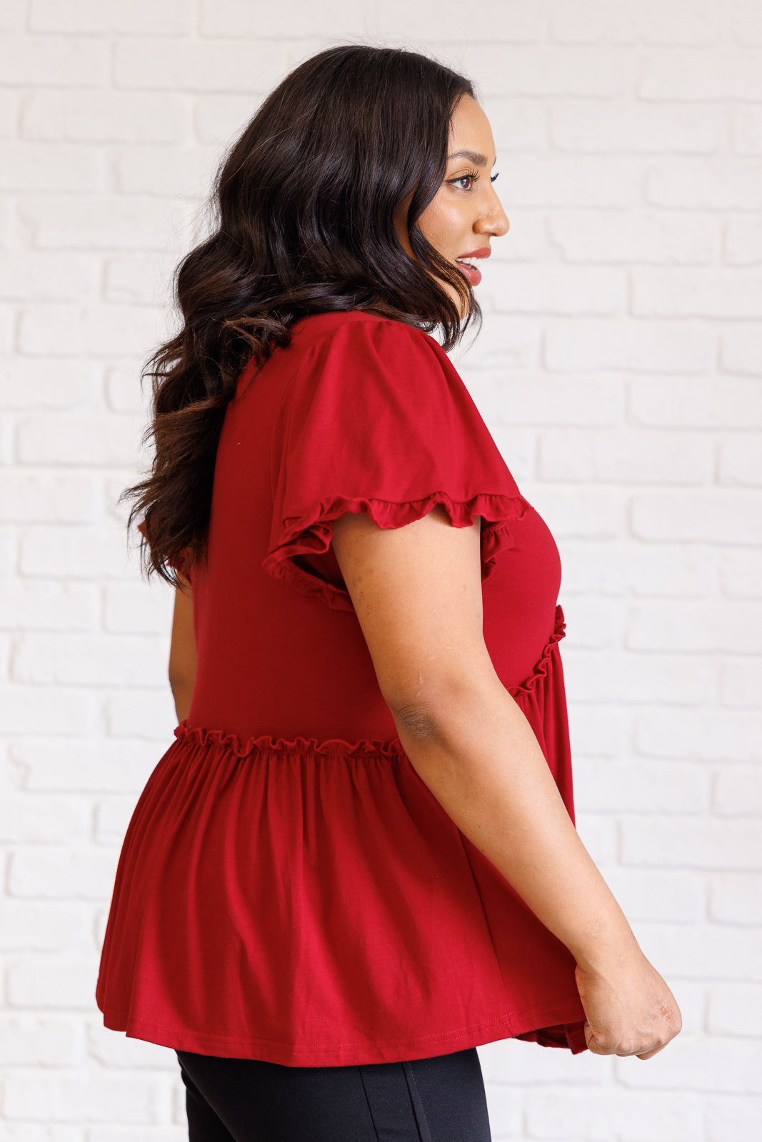 Ophelia V-Neck Ruffle Detail Top in red, featuring a flattering V-neckline, flutter sleeves, peplum silhouette, and charming ruffle accents, perfect for casual or polished occasions.