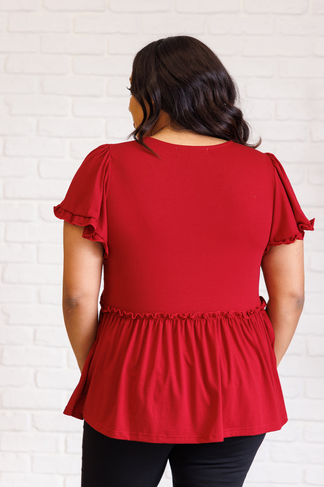 Ophelia V-Neck Ruffle Detail Top in red, featuring a flattering V-neckline, flutter sleeves, peplum silhouette, and charming ruffle accents, perfect for casual or polished occasions.