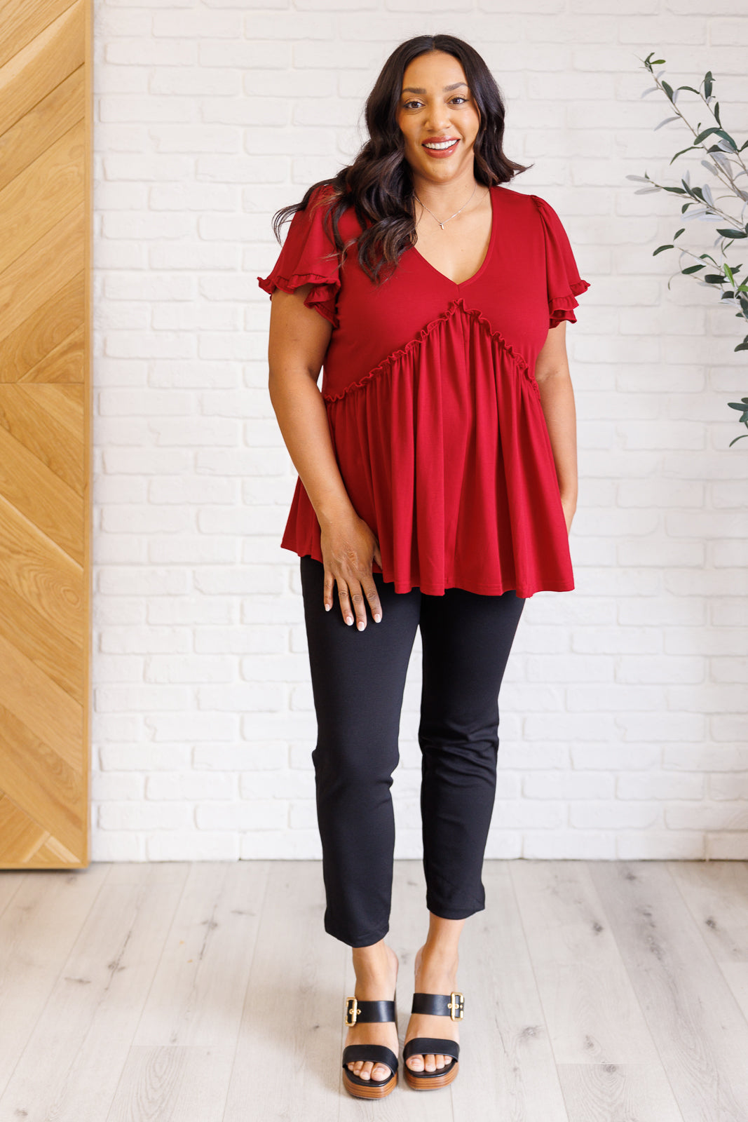 Ophelia V-Neck Ruffle Detail Top in red, featuring a flattering V-neckline, flutter sleeves, peplum silhouette, and charming ruffle accents, perfect for casual or polished occasions.