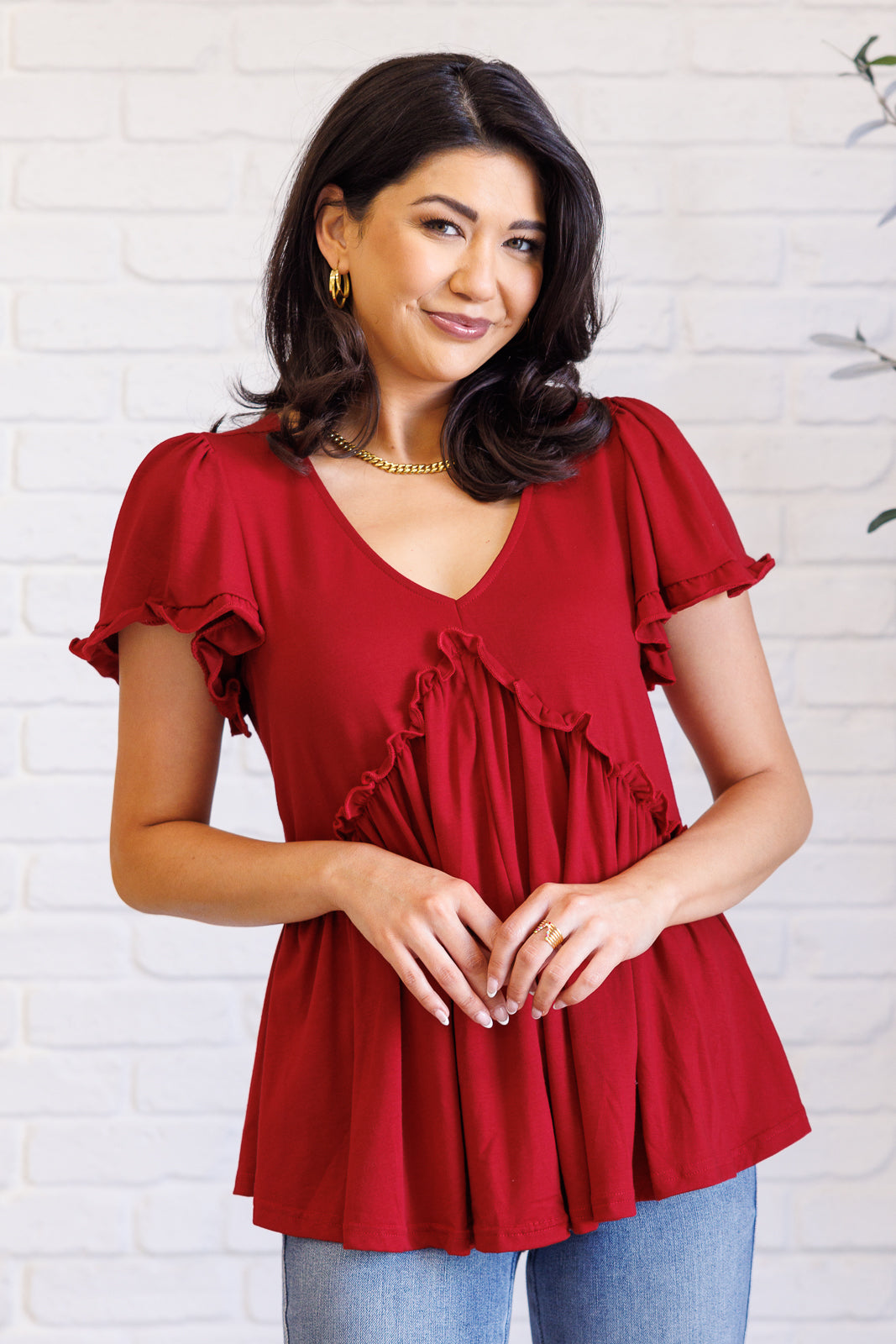 Ophelia V-Neck Ruffle Detail Top in red, featuring a flattering V-neckline, flutter sleeves, peplum silhouette, and charming ruffle accents, perfect for casual or polished occasions.