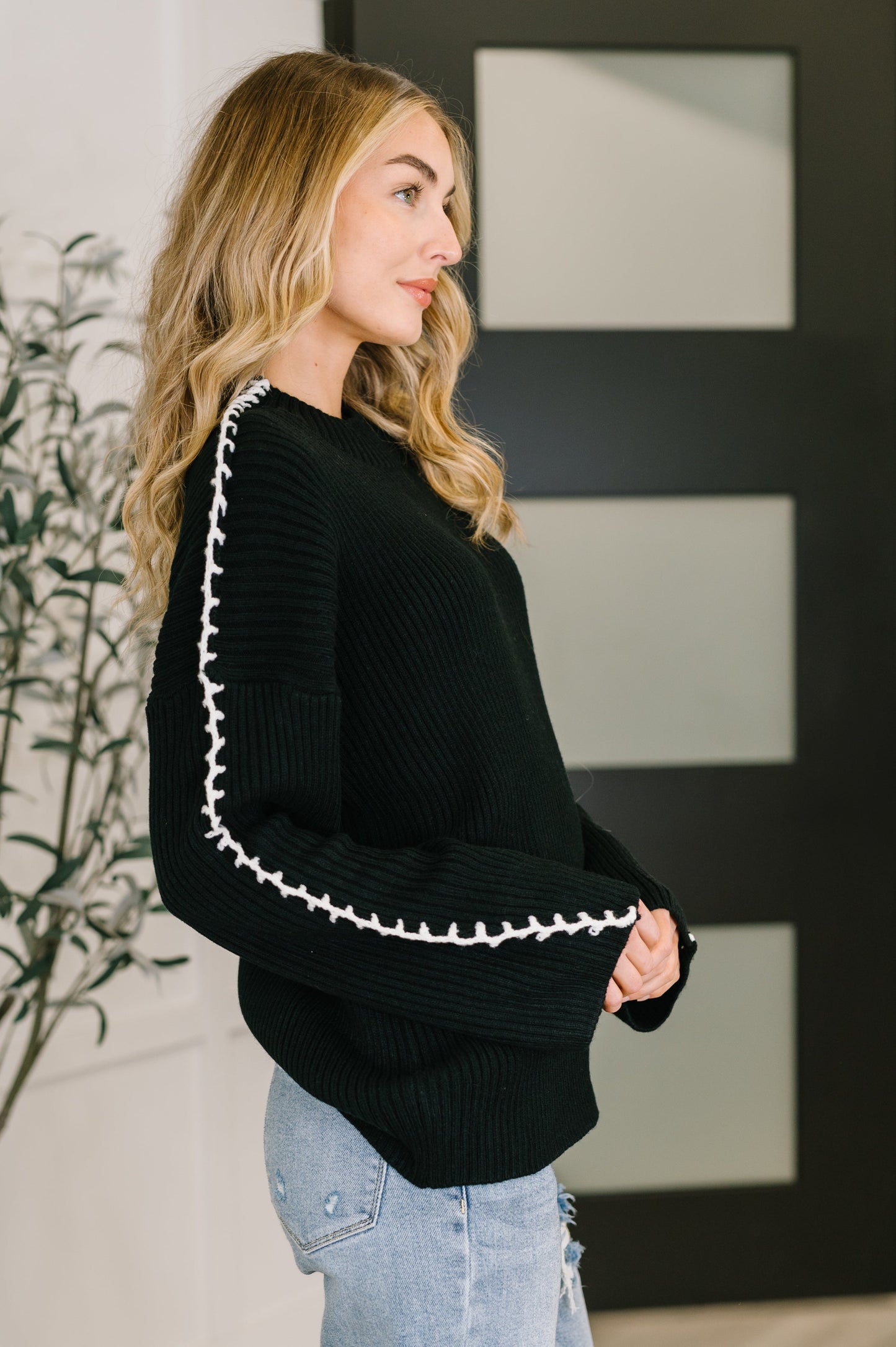 Side angle of Onyx Stitch Pullover highlighting ribbed texture and relaxed fit.