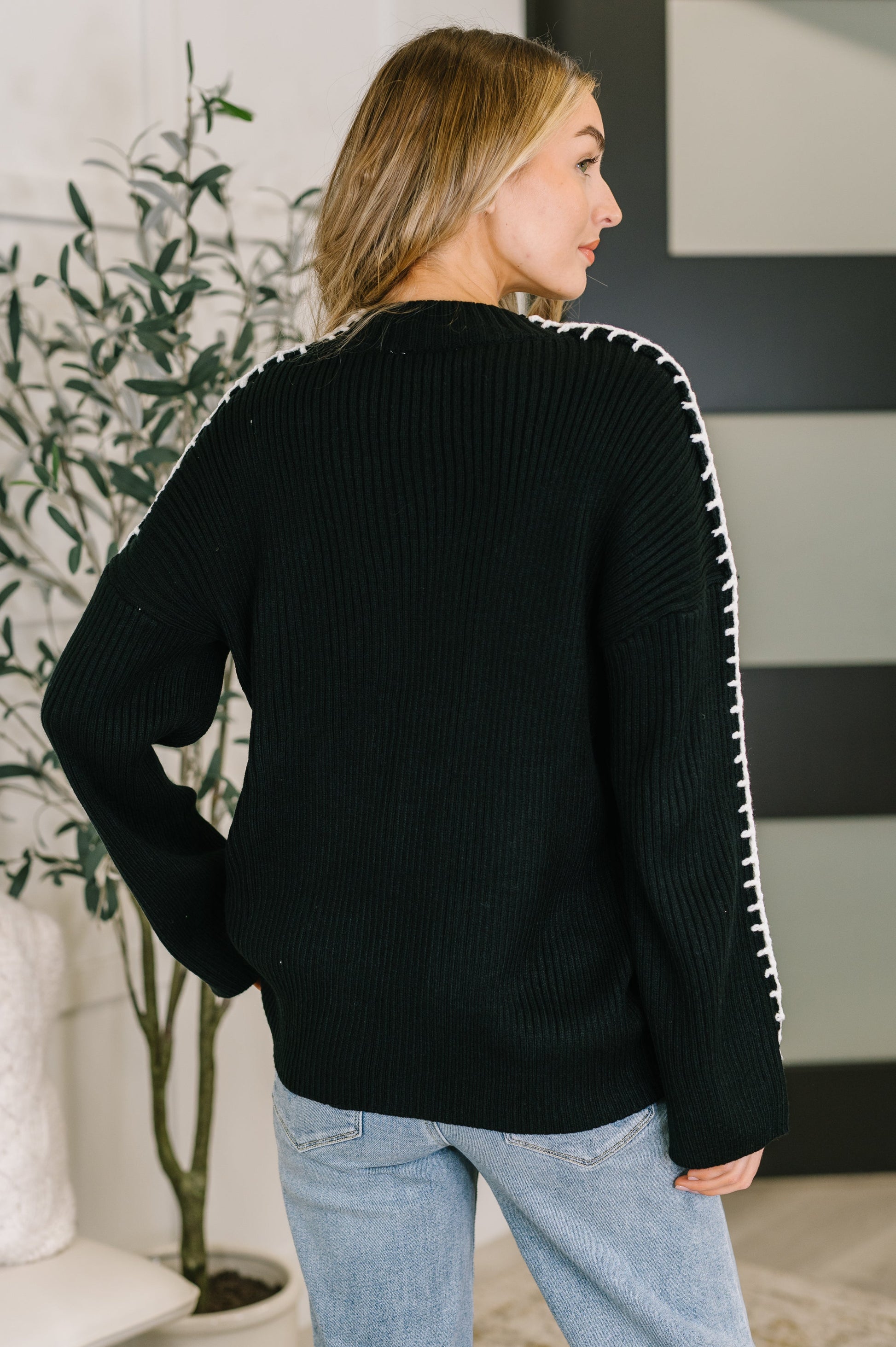 Back view of Onyx Stitch Pullover in black showing drop shoulder silhouette.