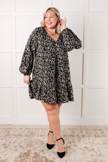 Plus size model wearing Onna V-Neck Floral Dress in black ditsy floral print.