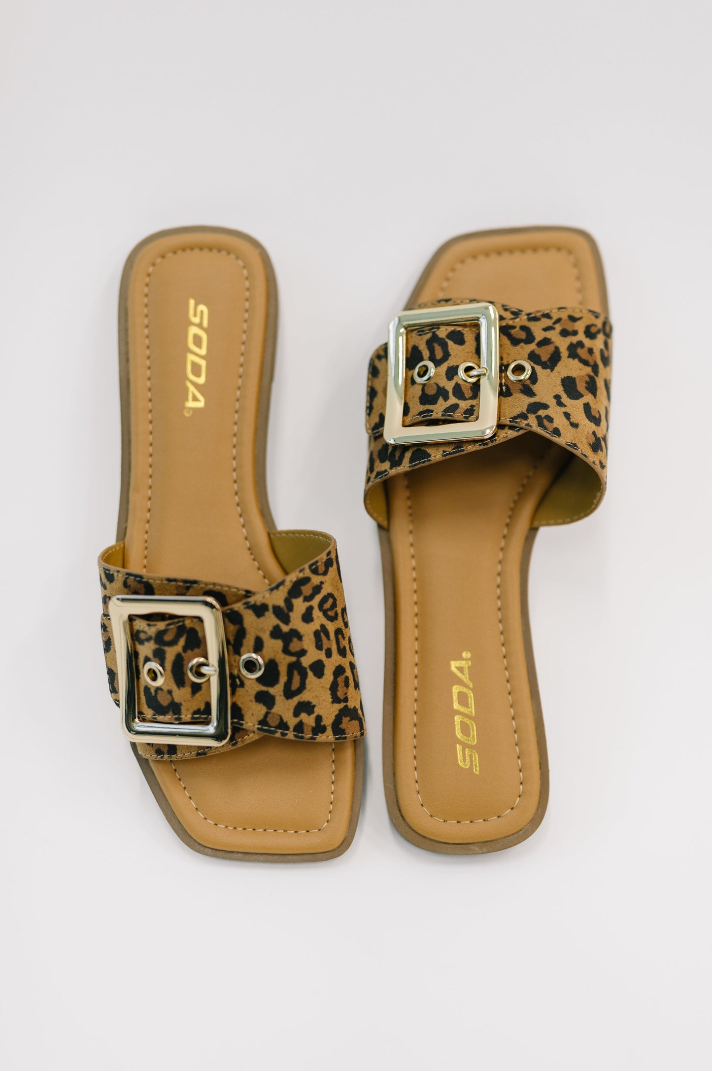 Flat lay of Opera Square Toe Buckle Slip On Sandal by Soda casual leopard slide sandals.