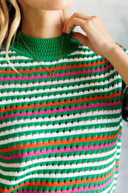 Close up view of the Sitarah Knit Striped Top in green with orange, white, and pink stripes, featuring a high-stretch sweater knit, round neckline, and half sleeves for a trendy and comfortable fit.