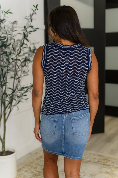 Back view of model wearing the Alena Navy Striped Tank Top, showcasing the scalloped hem and relaxed knit fit.