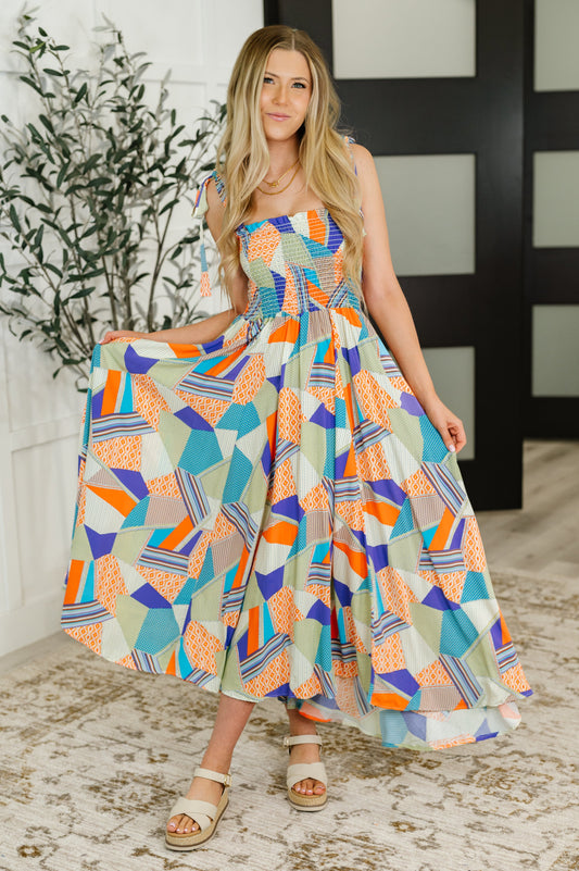 Full front view of model in Wrenleigh Maxi Dress, playfully holding skirt, styled with sandals
