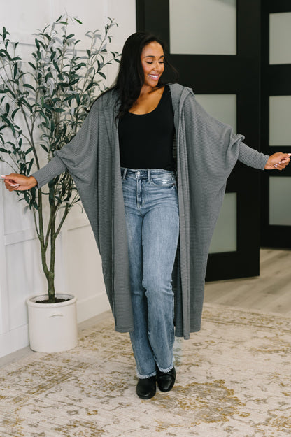 Full body view of model in Remington Hooded Cardigan in charcoal paired with jeans and black top.