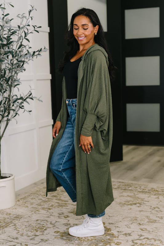 Side view of Remington Hooded Cardigan in olive showing relaxed dolman sleeves.