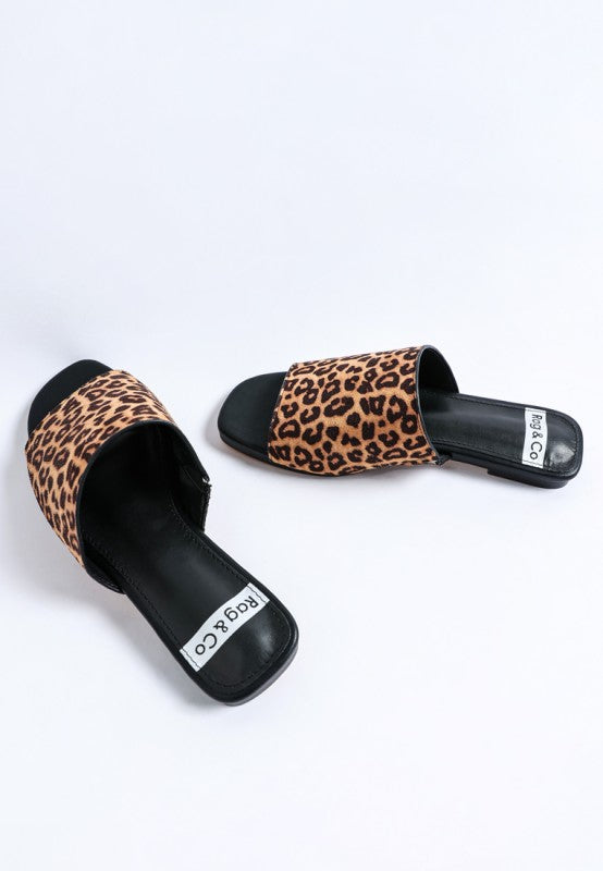 Back angle of Everyday Panthera Leopard Print Slider Flats flat sole casual slide shoes.