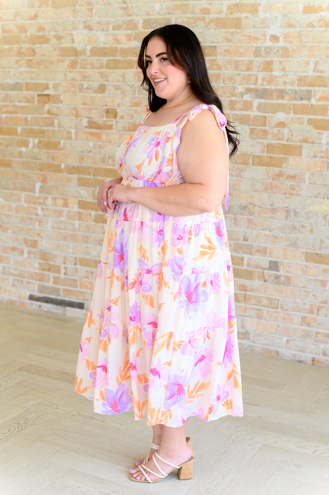 Lightweight pastel floral Pia Midi Dress crafted with functional tie straps, elastic waist, and fully lined tiered skirt for a romantic look.