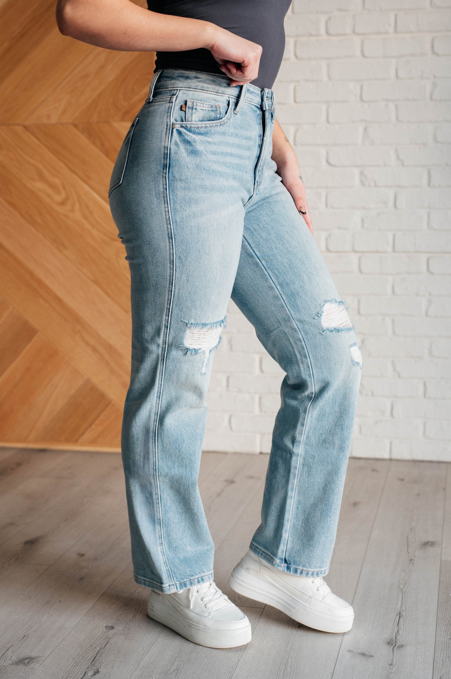 90s-inspired Patricia High Rise Rigid Magic Straight Jeans in a distressed light wash, featuring a classic straight-leg fit and a comfortable cotton-stretch denim blend for timeless style.