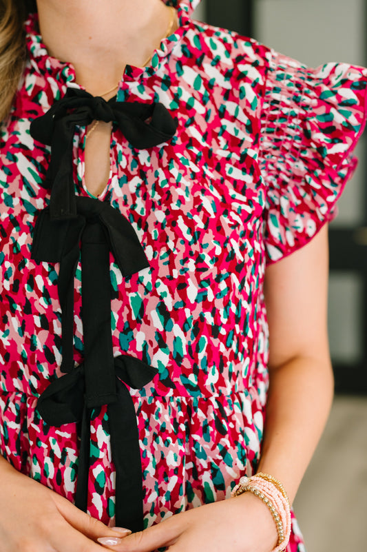 Close up of Jocelyn Bow Detail Dress showing black bow details and flutter sleeve.