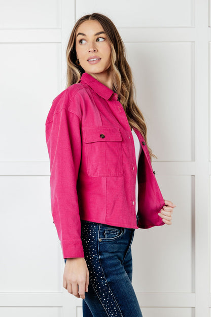 Side angle of Poppy Pink Jacket highlighting long sleeves and collared neckline.