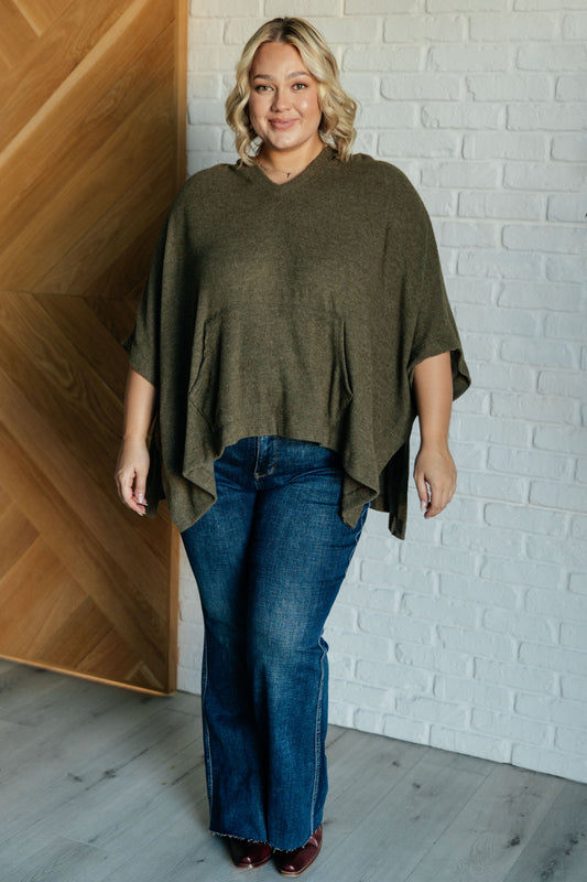 Plus size model full body in olive hooded poncho
