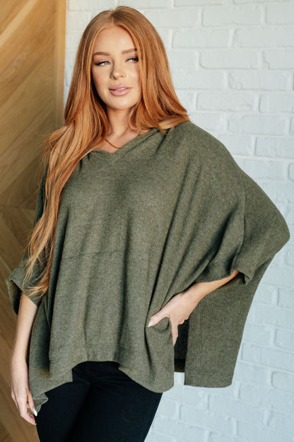 Front view of model wearing Salma Hooded Poncho in Olive