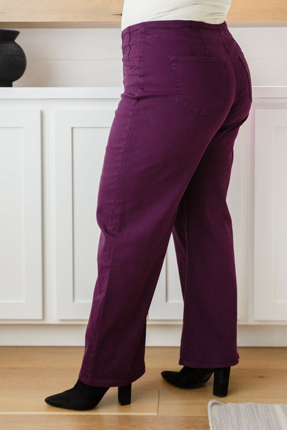 Plus size side view of Petunia Jeans in plum highlighting wide-leg drape and flattering high-rise waist.