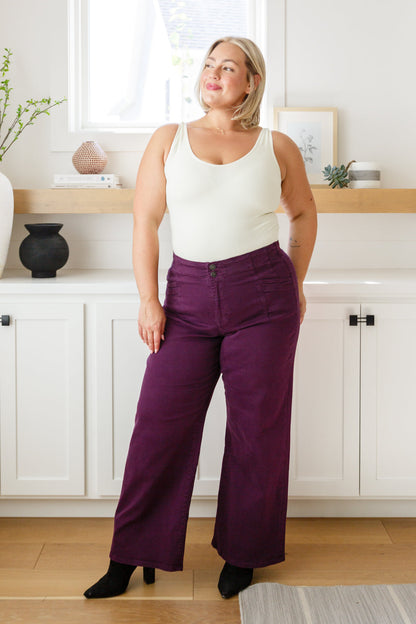 Plus size full body view of Petunia Jeans in plum wide-leg silhouette with chic tailored fit.
