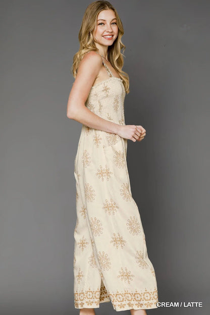 Side view of the Andie Smocked Printed Wide Leg Jumpsuit in cream, highlighting the flowy wide-leg fit and lightweight floral fabric.